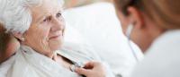 A female doctor examines a patient